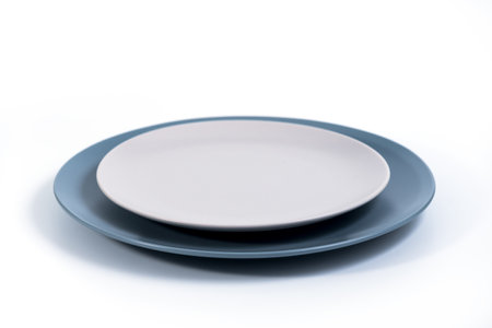 Dish set - Large Navy Blue and small Grey plates isolated on white background side view, selective focusの写真素材