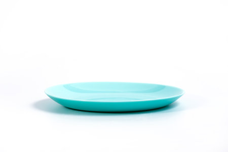 Empty Turquoise plate isolated on white background side view, selective focusの写真素材
