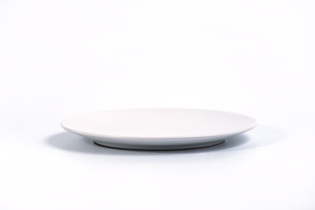 Empty White plate isolated on white background side view, selective focusの写真素材