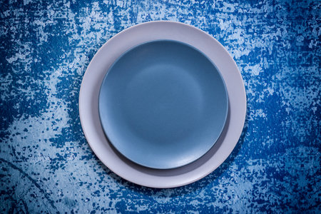 Grey and Blue Dish set on blue rustic background. Selective focus. Shot from aboveの写真素材