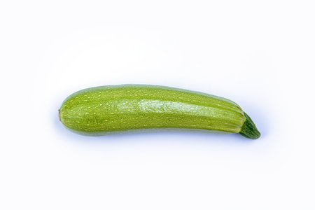 Courgette or Zucchini - green spotted vegetable for cooking vegetarian and healthy food, agricultural product isolated on white backgroundの写真素材