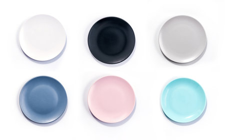 Set of six colorful empty plates isolated on white background top view. White, Black, Grey, Navy Blue, Pink, and Turquoise empty plates collectionの写真素材