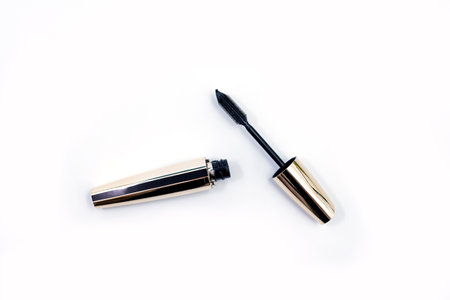 Mascara Black Bottle and Applicator Brush. Fashionable cosmetics Makeup for Eyes, Black Mascara wand and Tube Isolated on White. Extensible mascara and volume.の写真素材