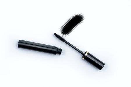 Black mascara applicator brush with sample smudge white isolated backgroundの写真素材