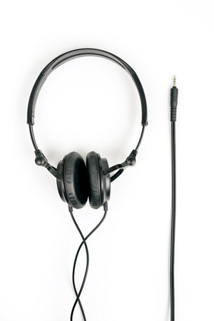 Black headphones on white background with 3,5 mm jack for plug inの写真素材