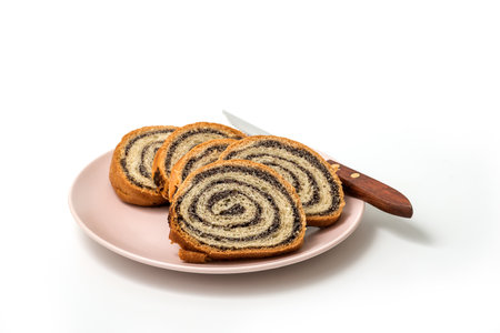 Homemade poppy seeds pie isolated on white background, dessert and decoration for Christmas, rolled up traditional poppy pieの写真素材