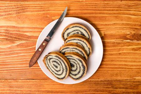 Homemade Poppy seeds pie on old wooden table - top view, dessert and decoration for Christmas, rolled up traditional poppy pieの写真素材