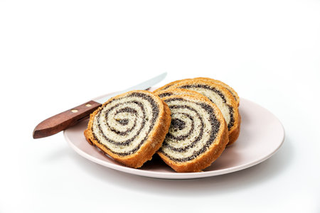 Homemade poppy seeds pie isolated on white background, dessert and decoration for Christmas, rolled up traditional poppy pieの写真素材
