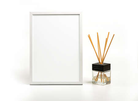 White vertical picture frame and incense decoration on white backgrtound. Clipping path for a 

frameの写真素材
