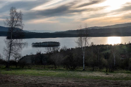 Magical Sunset over the lake with a beautiful reflection on the water. Serene lake in blue hour. Nature landscapeの写真素材