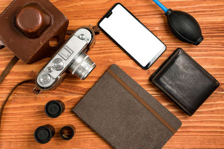 Journalistic equipment - notebook, phone, camera, lens, wallet and different objects. Vintage and modern concept. Freelancers outfit. Clipping mask for screenの写真素材