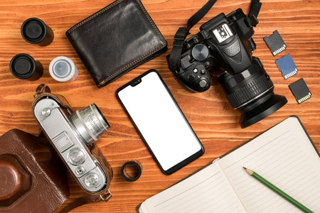 Journalistic equipment - notebook, phone, camera, lens, wallet and different objects. Vintage and modern concept. Freelancers outfit. Clipping mask for screenの写真素材
