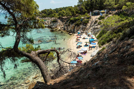Mega Portokali Beach - Orange Beach, Chalkidiki, Greece - JULY 8, 2021: Aegean sea coast landscape and beautiful samll beach in the cove.のeditorial素材