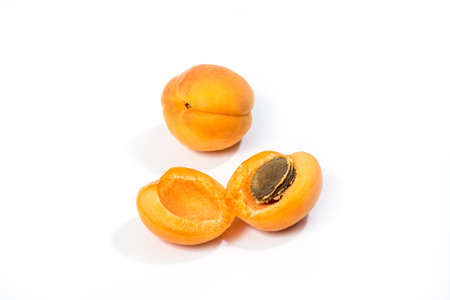 Fresh apricot fruits. Apricot isolated on white background. Sweet open apricots with kernel closeup. Top viewの写真素材