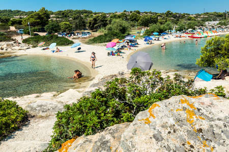 Lagonisi Beach - Sithonia, Chalkidiki, Greece - JULY 8, 2021: Aegean sea coast landscape and beautiful samll beach in the cove.のeditorial素材