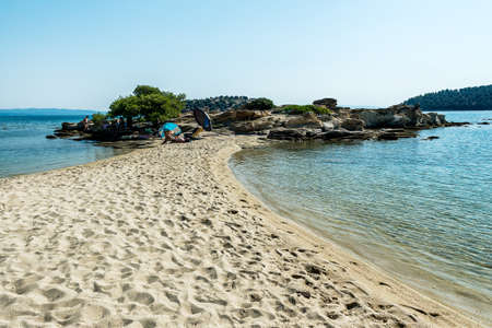 Lagonisi Beach - Sithonia, Chalkidiki, Greece - JULY 8, 2021: Aegean sea coast landscape and beautiful samll beach in the cove.のeditorial素材