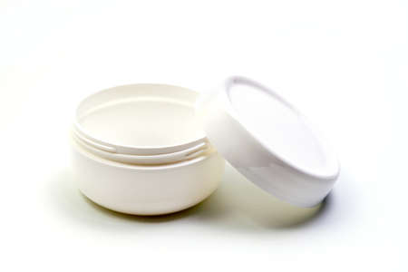 Empty White Plastic opaque cream jar with lid. Isolated on white background. Cosmetic product for skin careの写真素材