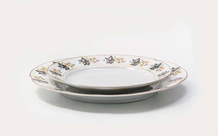 Luxury Vintage Porcelain tableware - Large and Small Plates on white background, side viewの写真素材