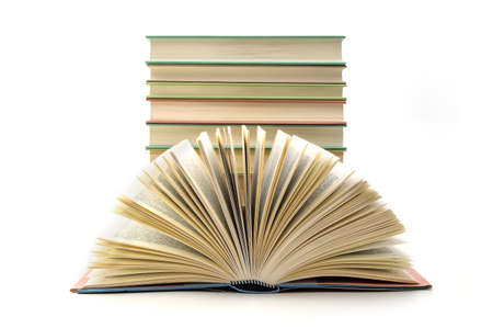 Stack of books with one book open on white background. A stack of books of different thicknesses, a pile of booksの写真素材
