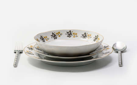 Luxury Vintage Porcelain tableware - Set of Plates with Utensils on white background, side viewの写真素材
