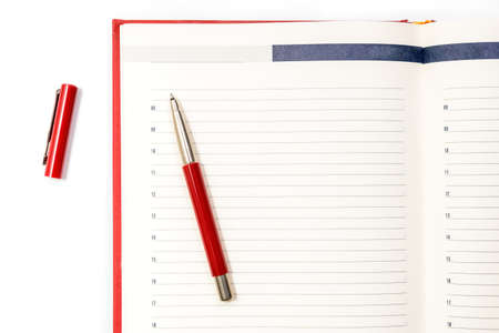 Open clean red notebook with red pen. Notebook, Education, school, college. Gaining knowledge, planning. View from above. Copy spaceの写真素材