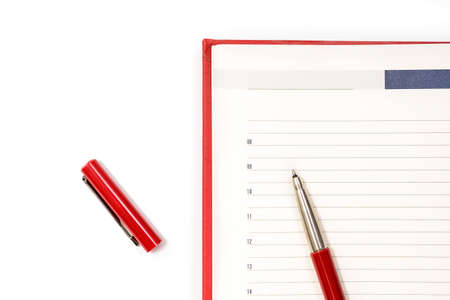 Open clean red notebook with red pen. Notebook, Education, school, college. Gaining knowledge, planning. View from above. Copy spaceの写真素材