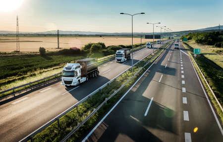 Portable Oxygen Cylinder Canisters Transportationn. Fleet of transportation trucks driving on highway. delivering Medical oxygen needed for  patientsの写真素材
