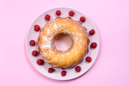 Homemade Kouglof cake with icing sugar dressing and Raspberries. Gugelhupf, Kugelhupf or Christmas Cake. Top Viewの写真素材