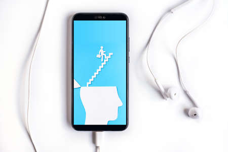 Smartphone with Uplifting and business prosper Concept, Paper Cut Open head with stairs upの写真素材