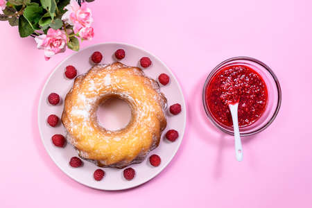 Homemade Kouglof cake with icing sugar dressing, Raspberries and Raspberry Filling. Gugelhupf, Kugelhupf or Christmas Cake. Top Viewの写真素材