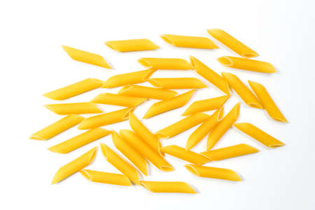 Raw uncooked Italian penne rigate pasta isolated on white backgroundの写真素材