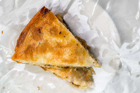 Burek Traditional Pie With Meat in paper unwrapped. Traditional Balkan breakfast. Top Viewの写真素材