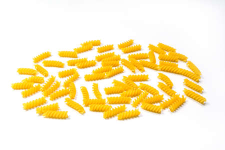 Raw Fusilli pasta, isolated on white background, selective focus. Italian pastaの写真素材