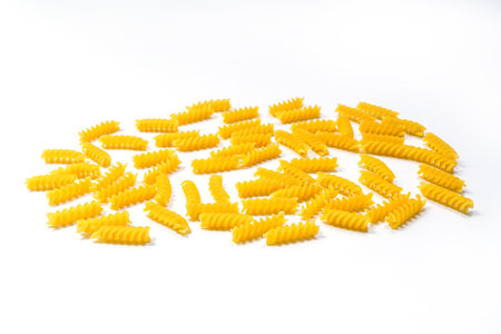 Raw Fusilli pasta, isolated on white background, selective focus. Italian pastaの写真素材