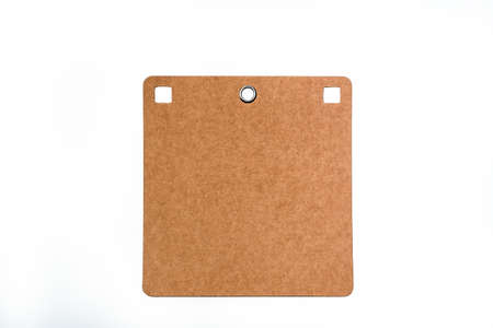 Large brown carton price tag with metal ring hole and with copy space isolated on white background - clipping path includedの写真素材