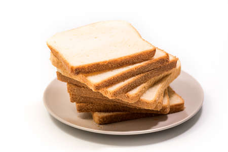 Stack of slices of toast bread for toasting in a plate isolated over white background with clipping...