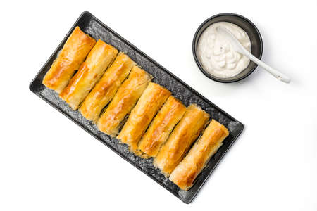 Meat rolls pastry - fried minced pork meat in spring rolls in a serving plate with a bowl of tartar 

sauce, isolated on white background with clipping path included. Top Viewの写真素材