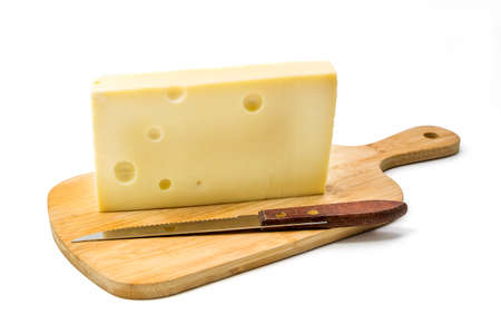 A piece of organic Emmental cheese with a knife on a wooden cutting board isolated over white 

background, clipping path includedの写真素材