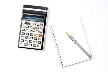 Calculator, pencil and notebook on white background. Close-up. Copy spaceの写真素材