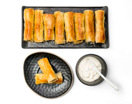 Meat rolls pastry - fried minced pork meat in spring rolls in a serving plate with a bowl of tartar sauce, isolated on white background with clipping path included. Top Viewの写真素材