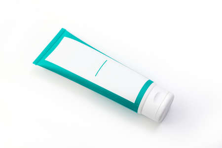 Cosmetic cream green tube. Sskincare cosmetic package. Plastic toothpaste tube. Product in green tubeisolated on white background. Clipping path included.の写真素材