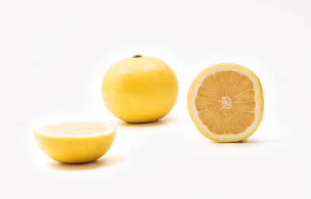 Isolated Yellow grapefruits. Whole Yellow grapefruit and slice of fresh grapefruit isolated on white backgroundの写真素材