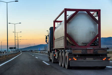 Tank Truck on a highway road under blue sunrise skyの写真素材