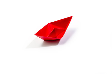 Red boat made from paper isolated on white backgroundの写真素材
