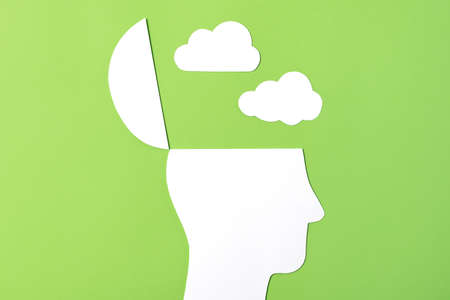 Dark Thoughts Concept, Paper Cut out Open head with paper cut out clouds aboveの写真素材