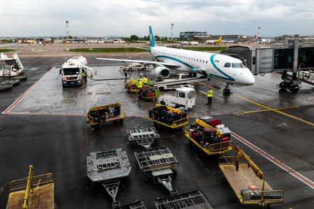 Belgrade, Serbia. April 22, 2022. Exterior or outside of the airport Nikola Tesla in Belgrade. Airplane and freight containers with luggage suitcases at the airport terminalのeditorial素材