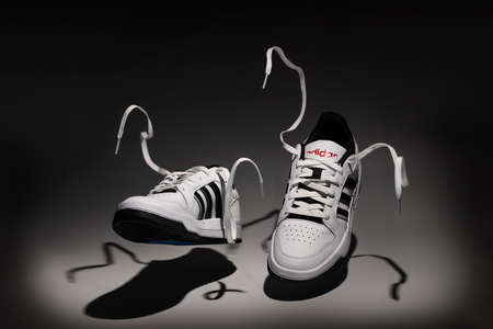 Belgrade, Serbia - May 12, 2022. New Adidas tennis shoes on white background sgot with studio lighting. New Adidas Sneakers or trainers on white background. Men's sport footwearのeditorial素材