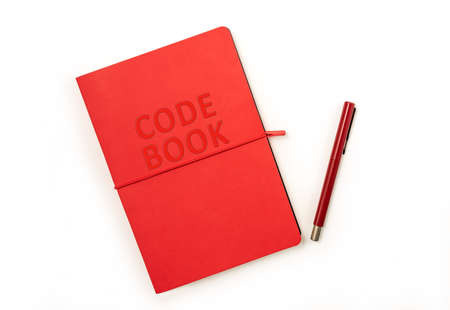 Red hardcover code book and red pen isolated on white background with copy space. Clipping parh...