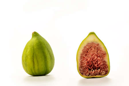 Ripe green figs and a sliced half on white background, clipping paths includedの写真素材