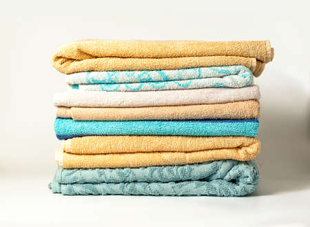 Different colors of towels isolated on white backgroundの写真素材